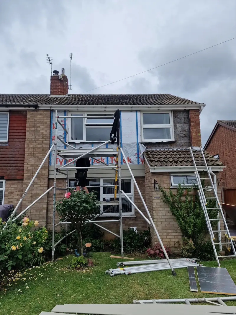 Scaffold tower and breathable membrane on a semi-detached house in Aldham while new cladding is fitted