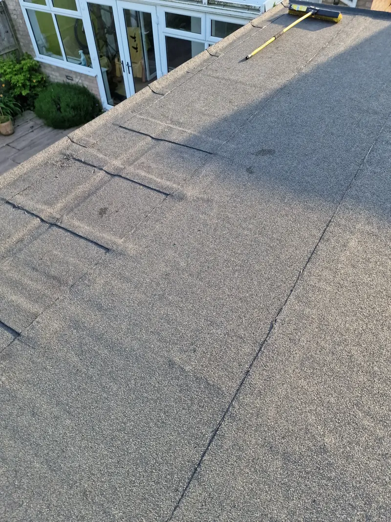 New mineral felt flat roof above a rear conservatory and patio doors