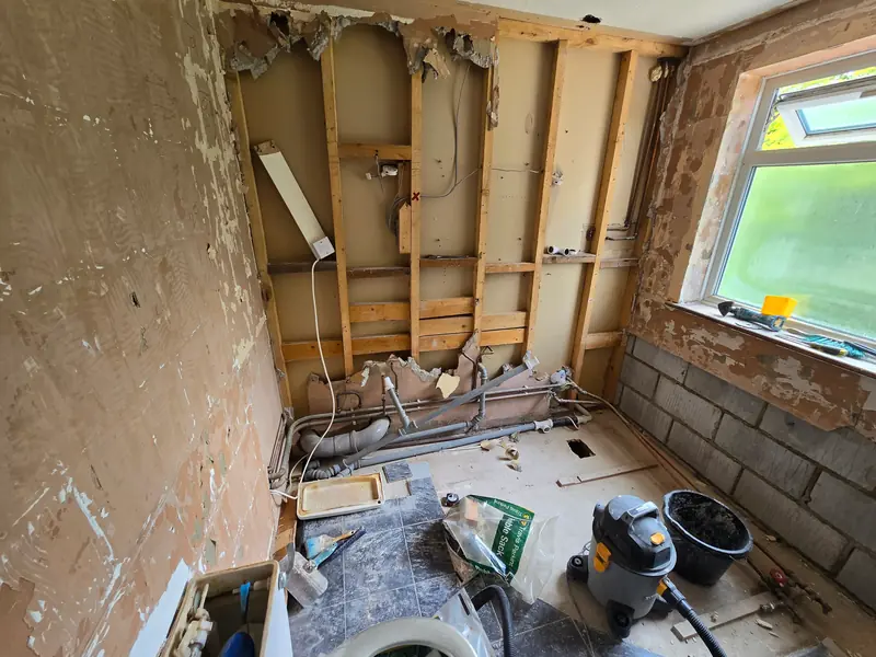 Bathroom in Alresford stripped back to the timber stud wall and blockwork during a refurbishment