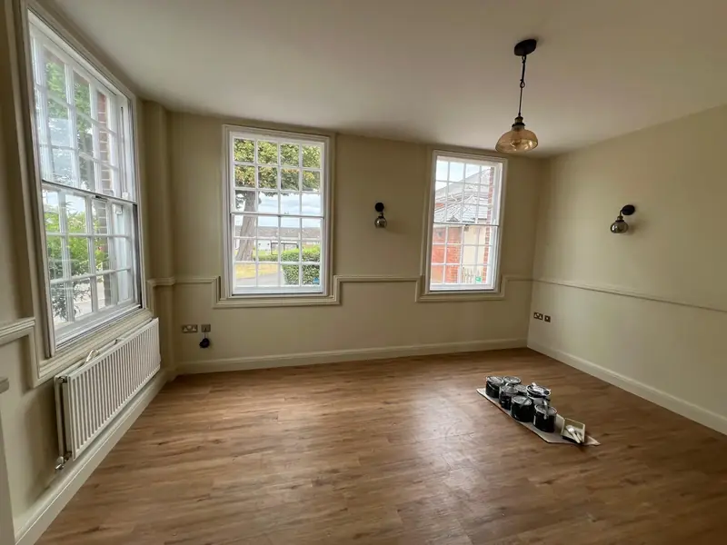 Refurbished room with sash windows and panel mouldings, finished by our team in Witham